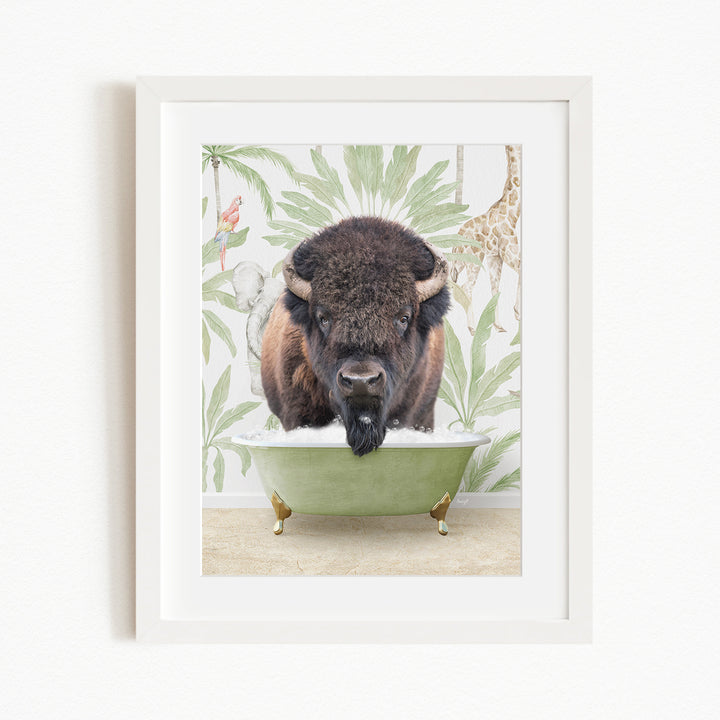 A framed image depicting a bison standing in a green bathtub, surrounded by tropical foliage and a giraffe.