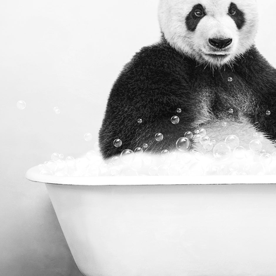 a black and white photo of a panda in a bathtub