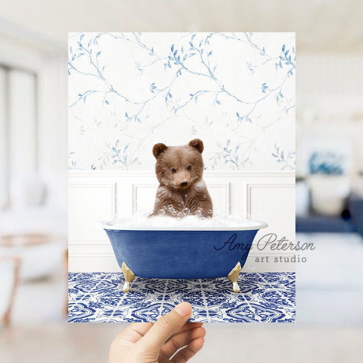 a person holding a card with a teddy bear in a bathtub