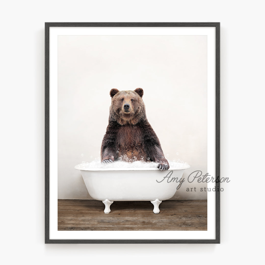 a brown bear sitting in a bath tub