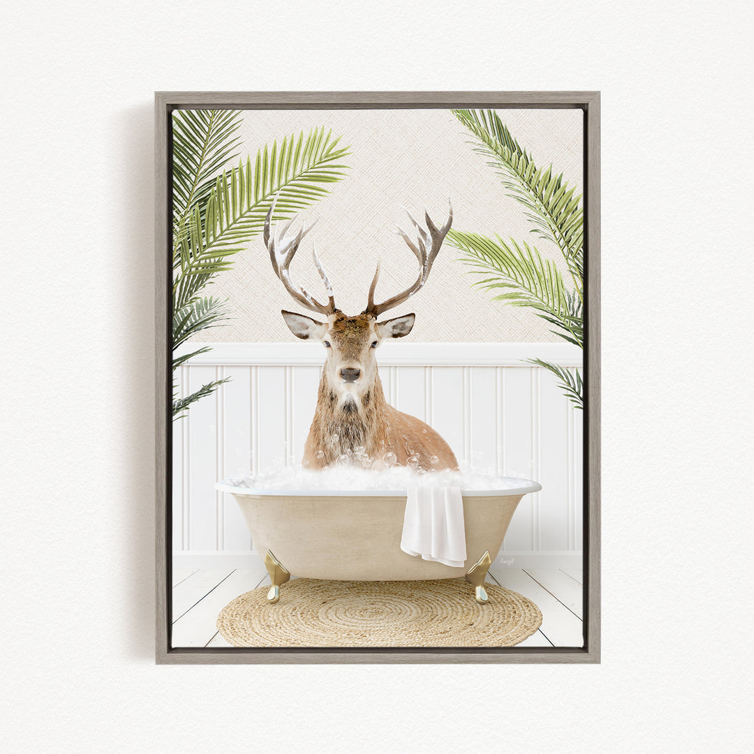 A deer with antlers is sitting in a bathtub filled with water, surrounded by green plants.