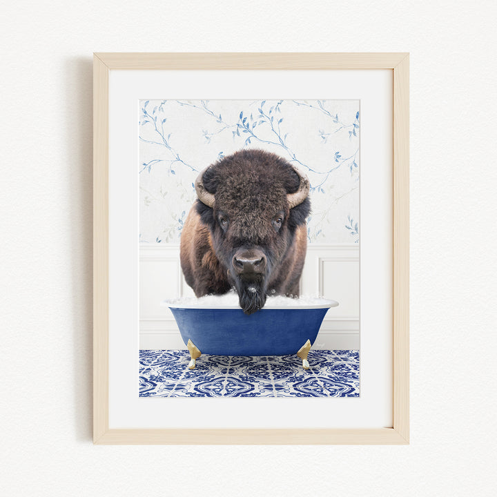 A buffalo standing in a blue bathtub filled with water, with a patterned tile floor in the background.