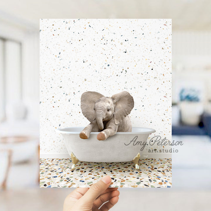 a hand holding up a card with an elephant in a bathtub