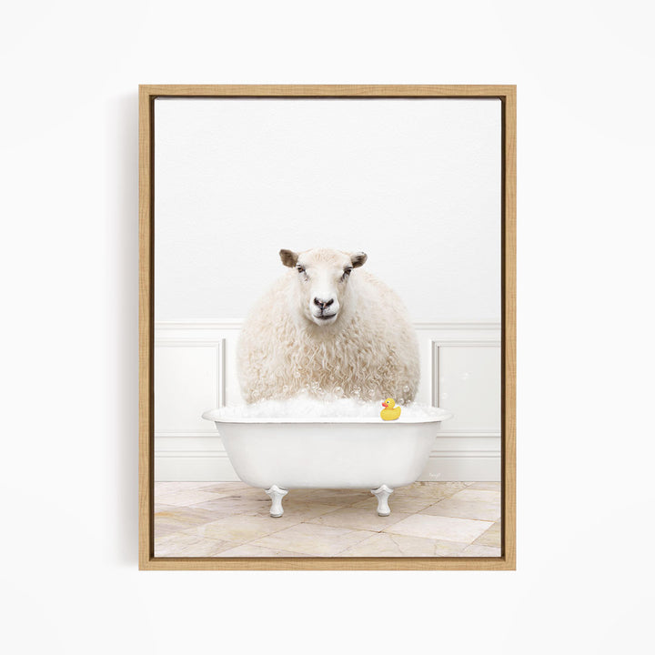 A fluffy white sheep sits in a white bathtub filled with bubbles, with a yellow rubber duck floating in the water.