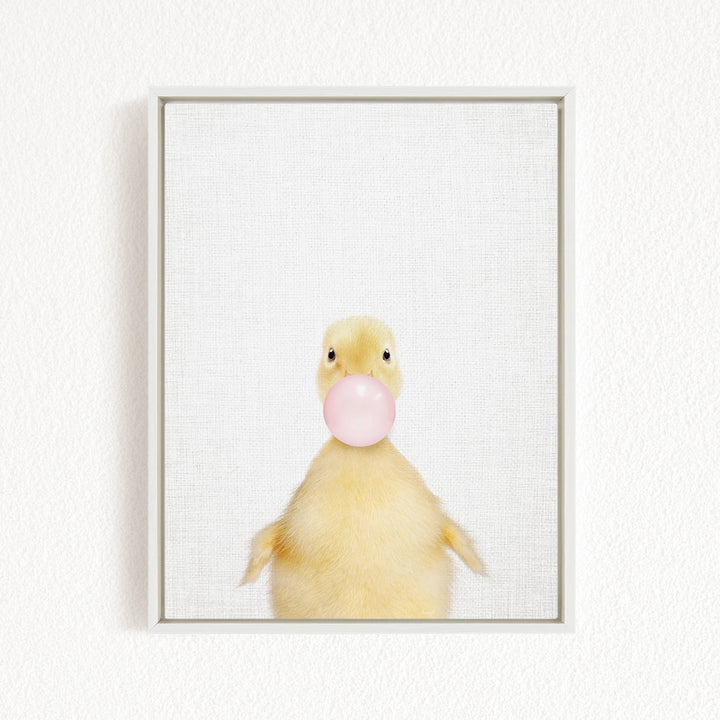 A cute yellow duck blowing a bubble with a pink bubble gum bubble.