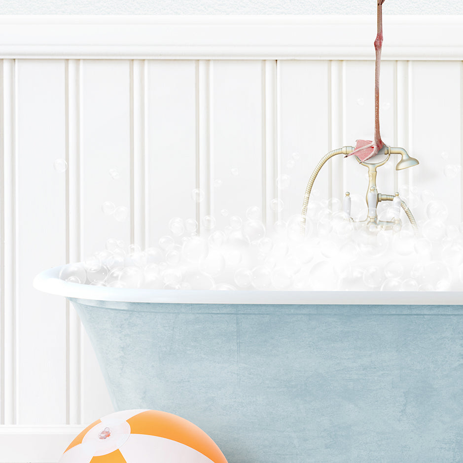 a bathtub filled with bubbles and a beach ball