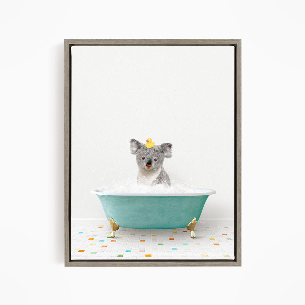A koala bear sitting in a blue bathtub filled with bubbles, wearing a yellow rubber duck hat.
