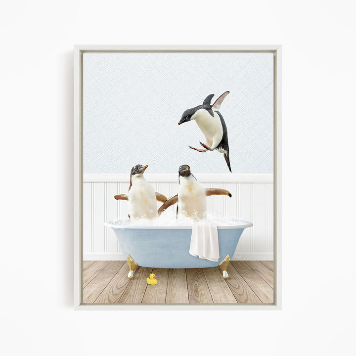 A framed image depicting two penguins sitting in a bathtub, with one penguin flying towards the other penguin.