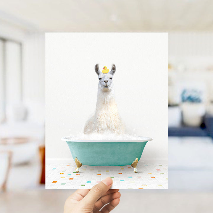A white llama sitting in a green bathtub filled with bubbles, wearing a yellow rubber duck on its head.