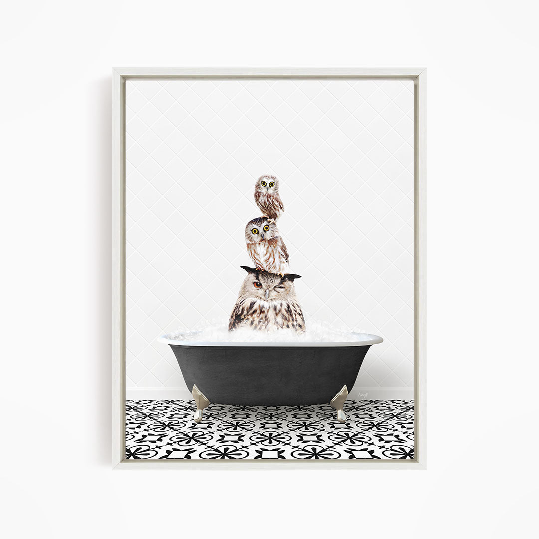 A framed image depicting three owls sitting in a bathtub filled with water, creating a whimsical and playful scene.