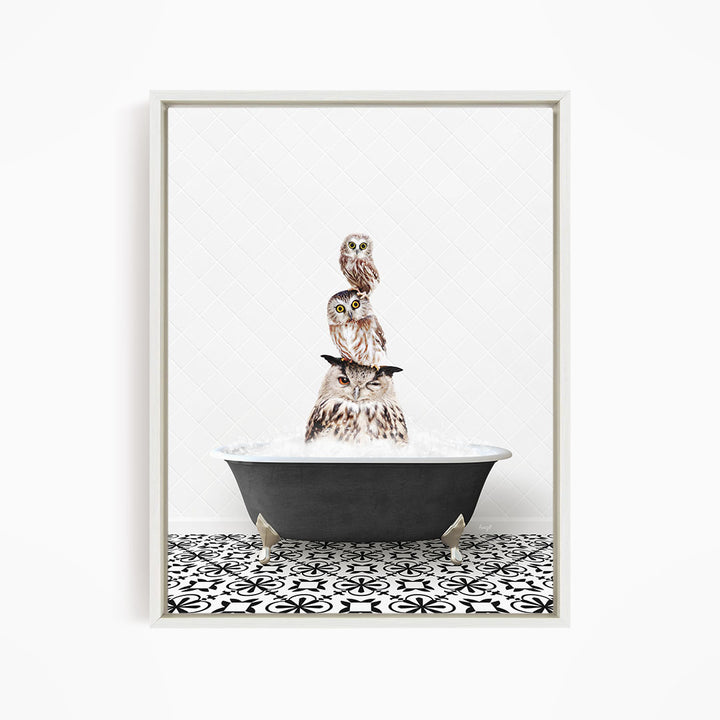 A framed image depicting three owls sitting in a bathtub filled with water, creating a whimsical and playful scene.