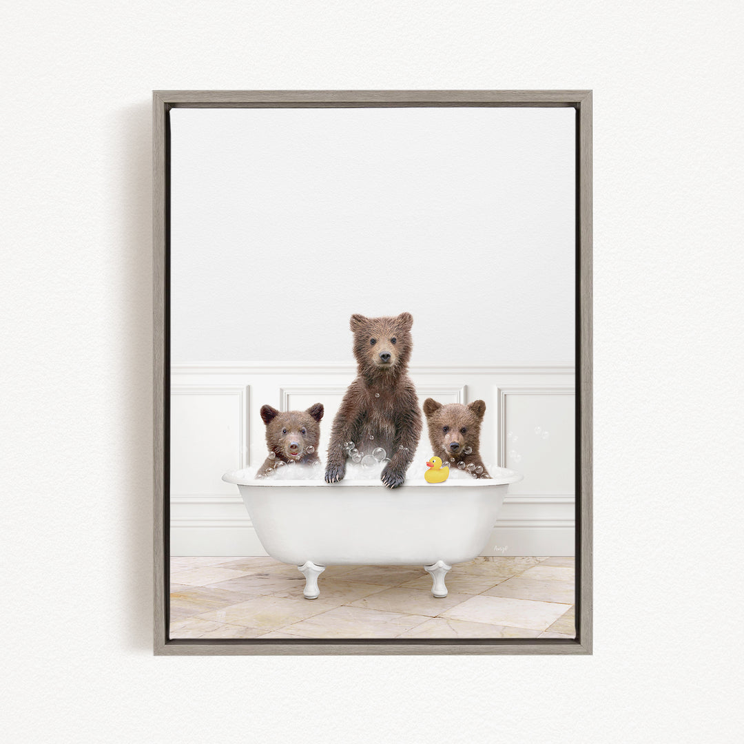 A framed image showing three bears sitting in a white bathtub, with one bear holding a yellow rubber duck.