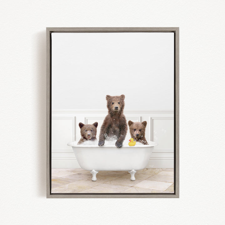 A framed image showing three bears sitting in a white bathtub, with one bear holding a yellow rubber duck.