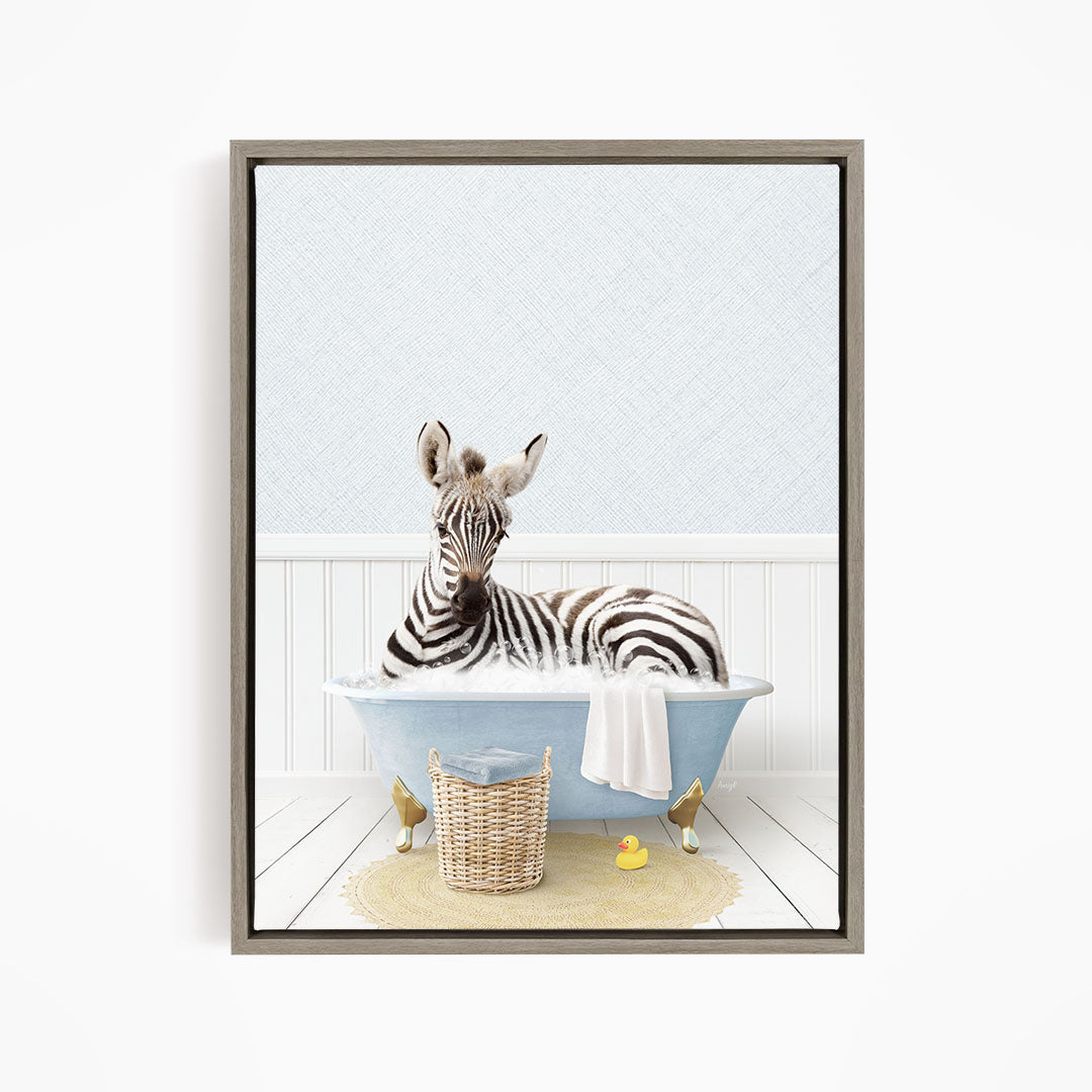 A zebra is sitting in a blue bathtub, surrounded by rubber ducks and a basket.