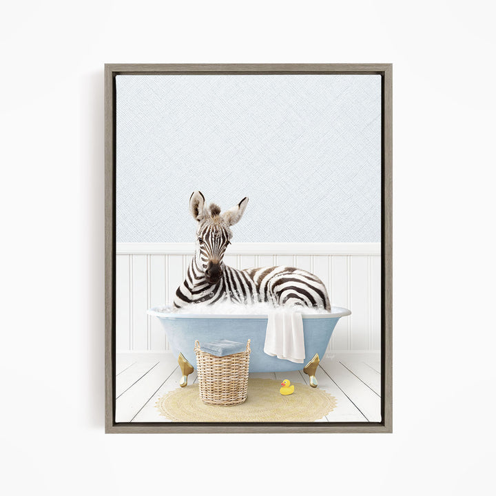 A zebra is sitting in a blue bathtub, surrounded by rubber ducks and a basket.