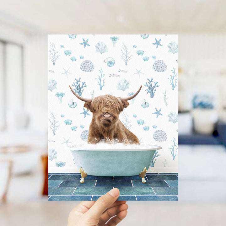 A brown cow with horns is sitting in a blue bathtub filled with bubbles, surrounded by a pattern of blue and white seashells and starfish.