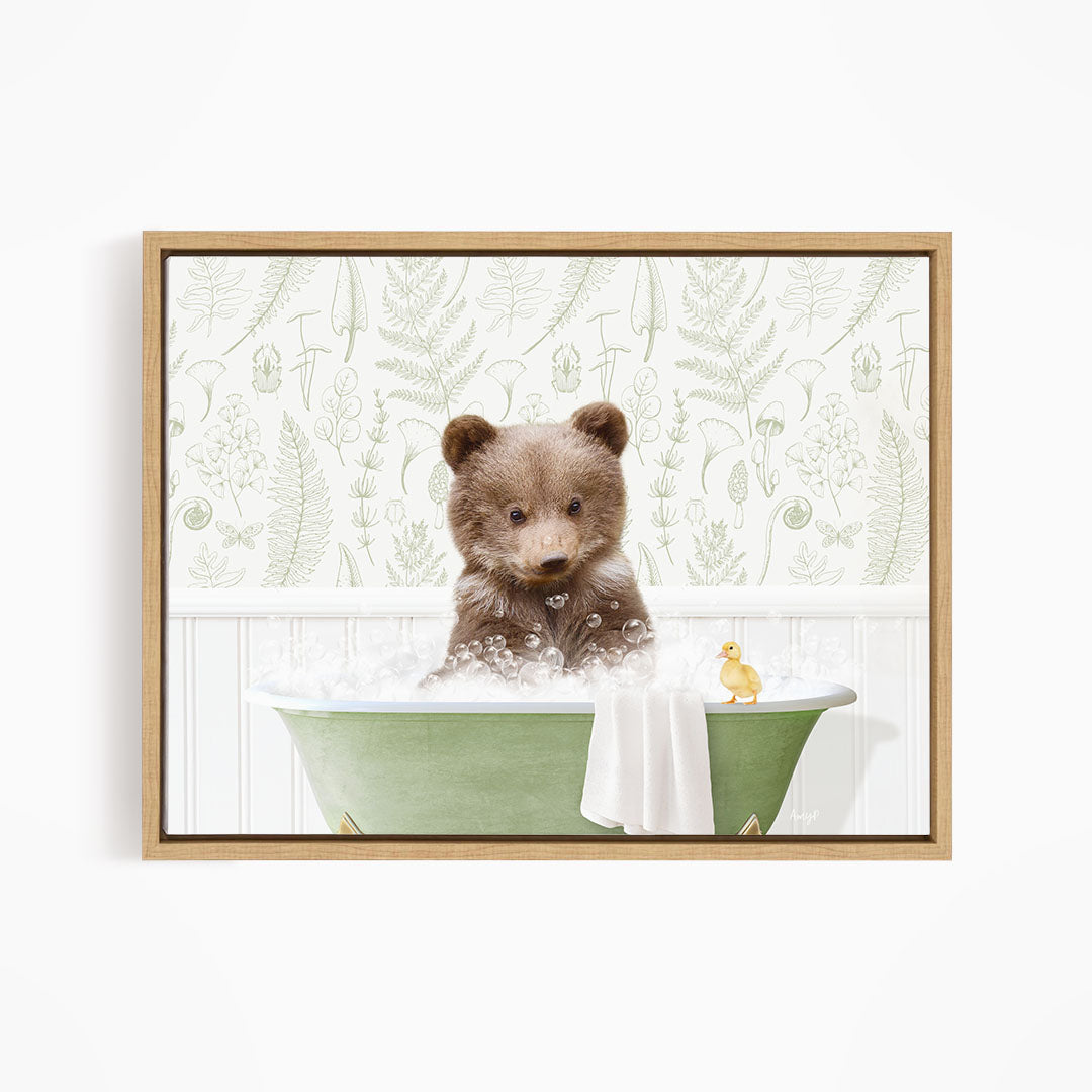 A brown bear sitting in a green bathtub, surrounded by a yellow duck and a white towel, against a backdrop of green ferns and other plants.