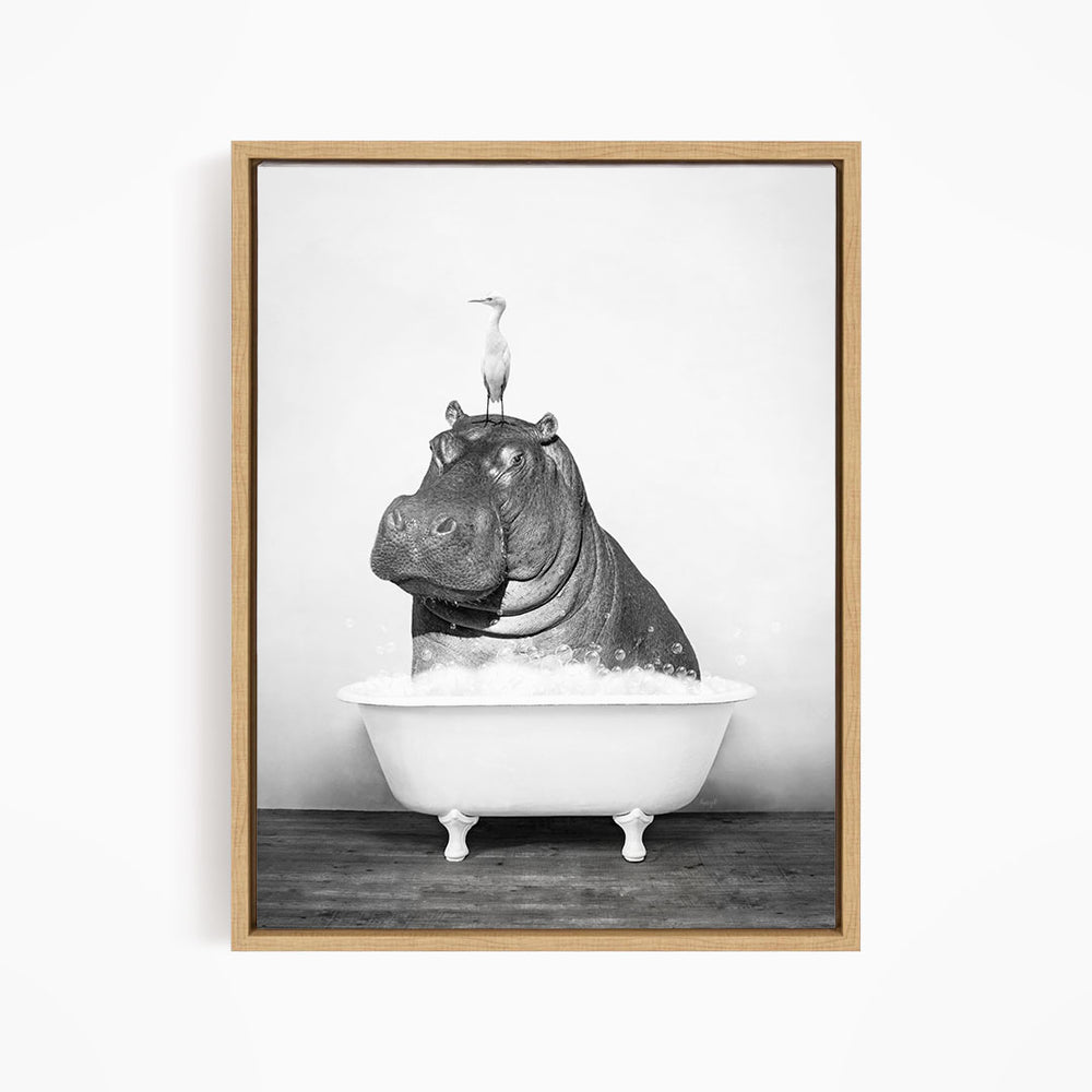 A black and white image of a hippopotamus sitting in a bathtub, with a bird perched on its head.