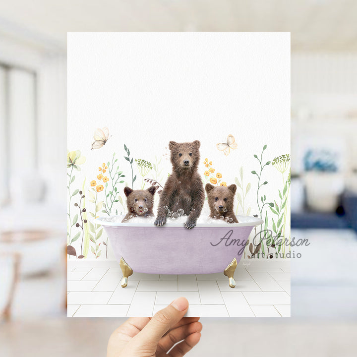 a person holding a card with three bears in a bathtub