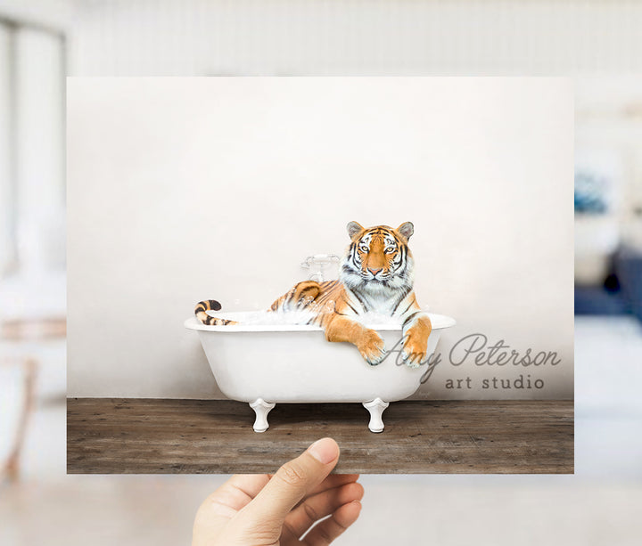 a hand holding up a card with a picture of a tiger in a bathtub