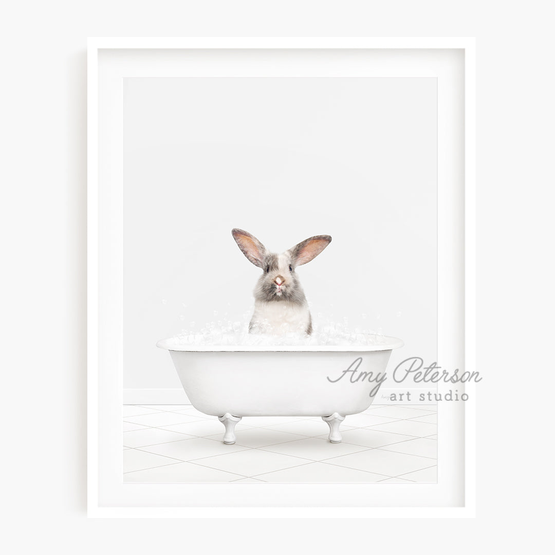 a rabbit sitting in a bathtub with water in it