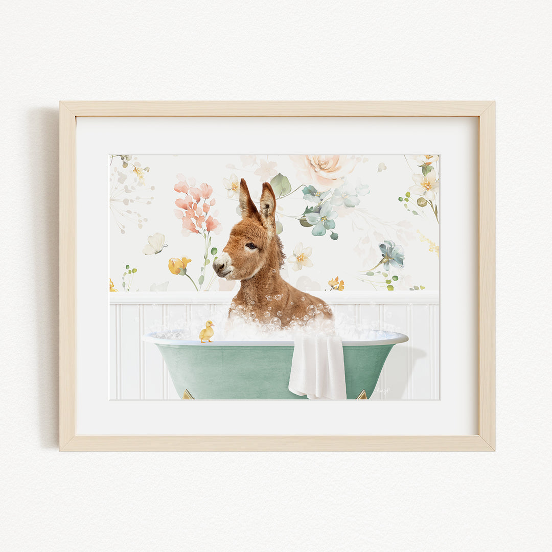 A brown kangaroo is sitting in a green bathtub filled with bubbles, surrounded by a floral background.