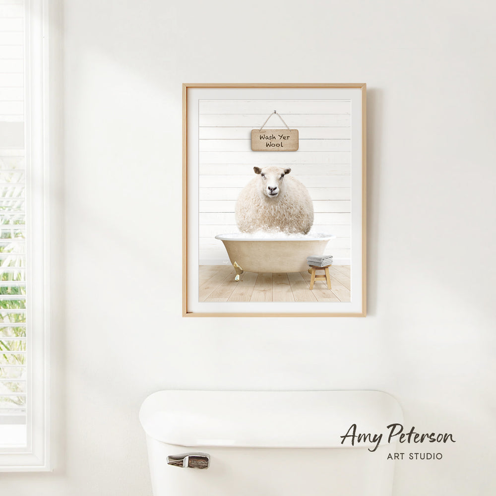 A framed image of a sheep sitting in a bathtub, with a sign above it that says "Wash Your Sheep".