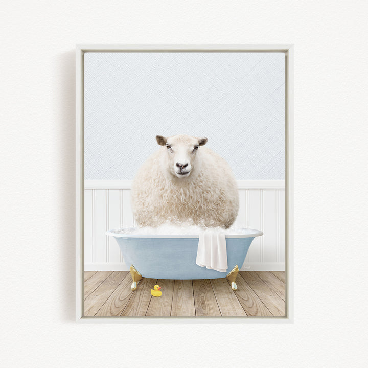A fluffy white sheep sits in a blue bathtub filled with bubbles, surrounded by rubber ducks on a wooden floor.