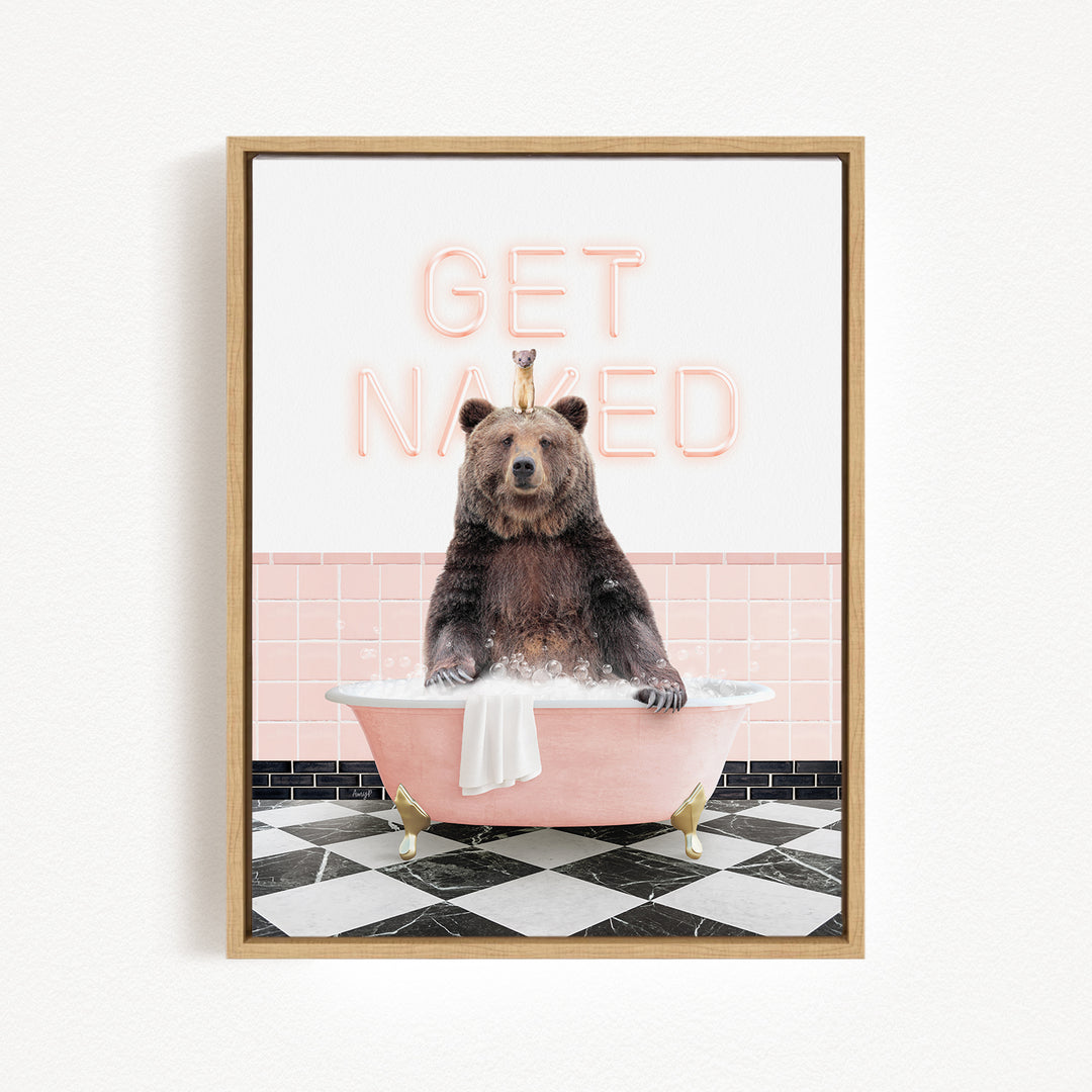 A brown bear sitting in a pink bathtub with the words "GET NAKED" written on the wall behind it.