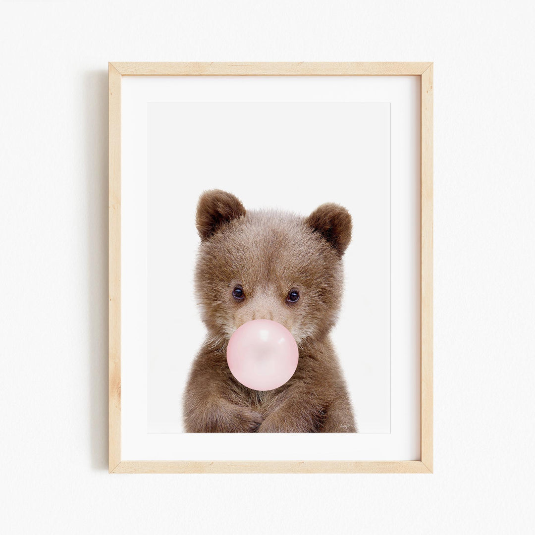 a picture of a brown teddy bear blowing a bubble