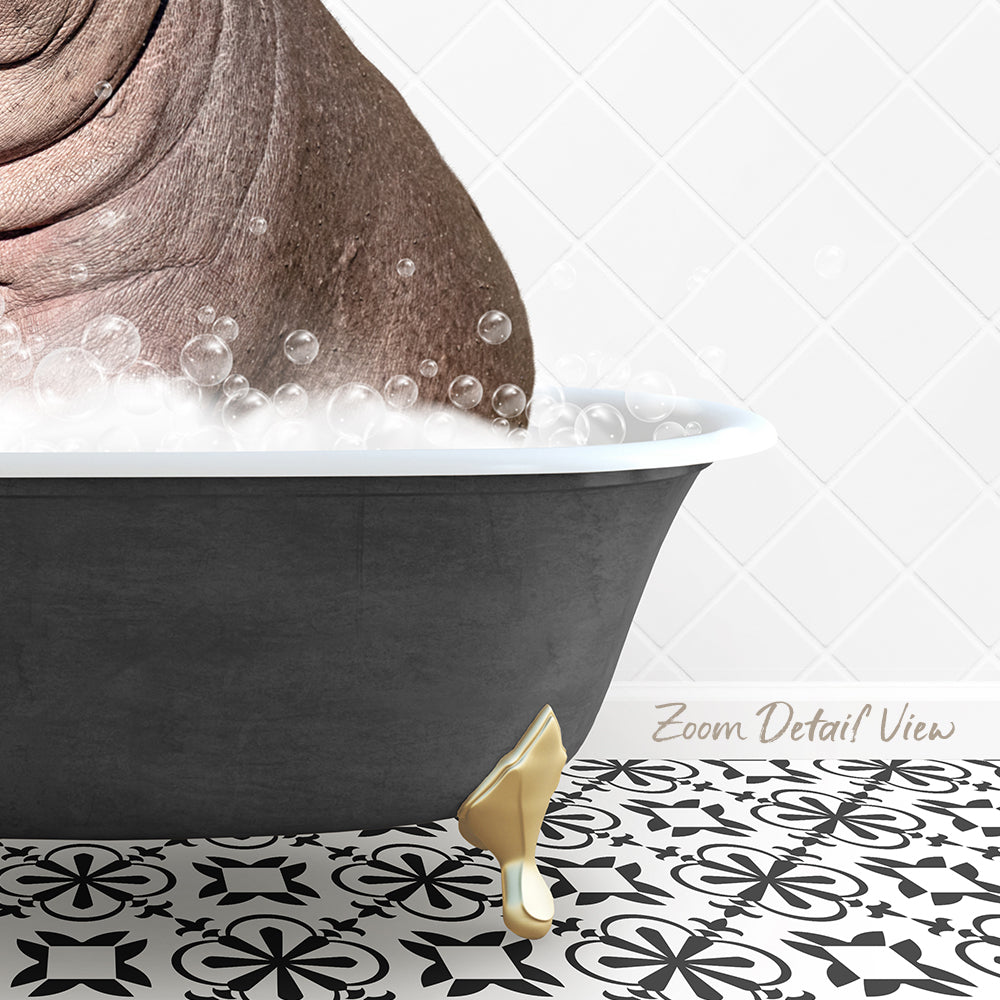 A black bathtub filled with bubbles, with a gold bathtub leg visible on the floor.
