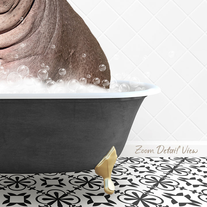A black bathtub filled with bubbles, with a gold bathtub leg visible on the floor.