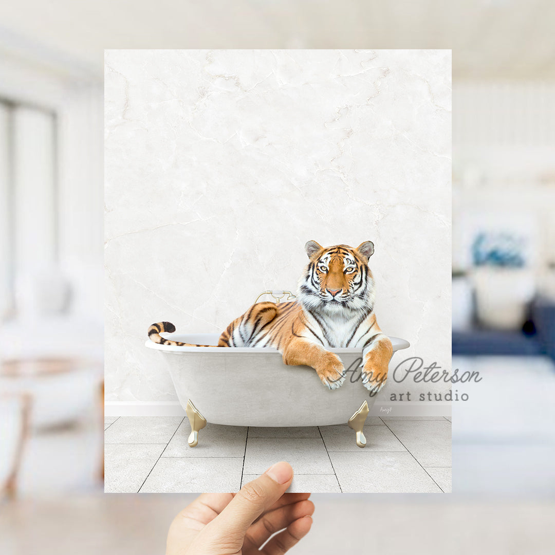 a hand holding up a picture of a tiger in a bathtub