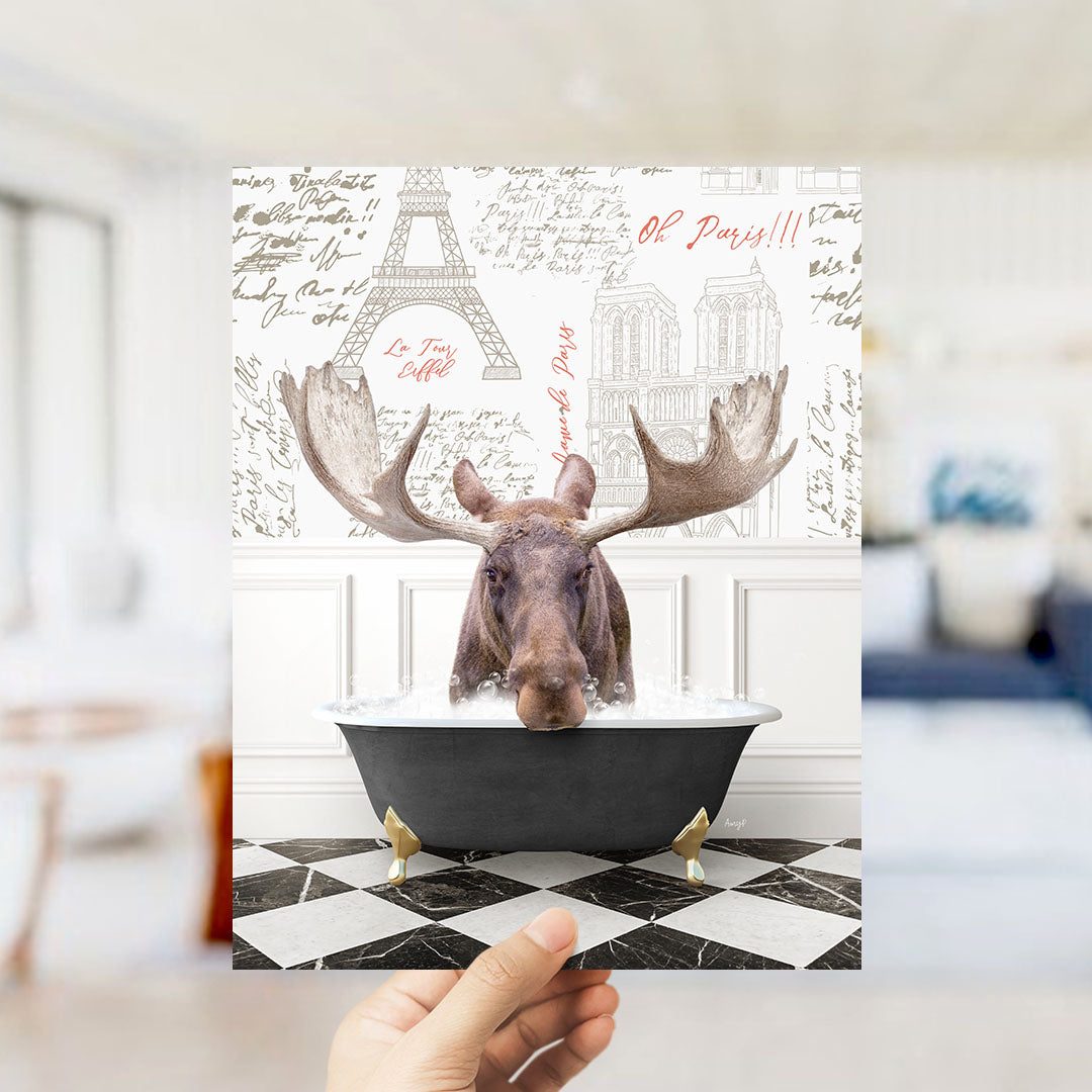 A moose is sitting in a bathtub filled with water, surrounded by various Paris-themed elements such as the Eiffel Tower and text.