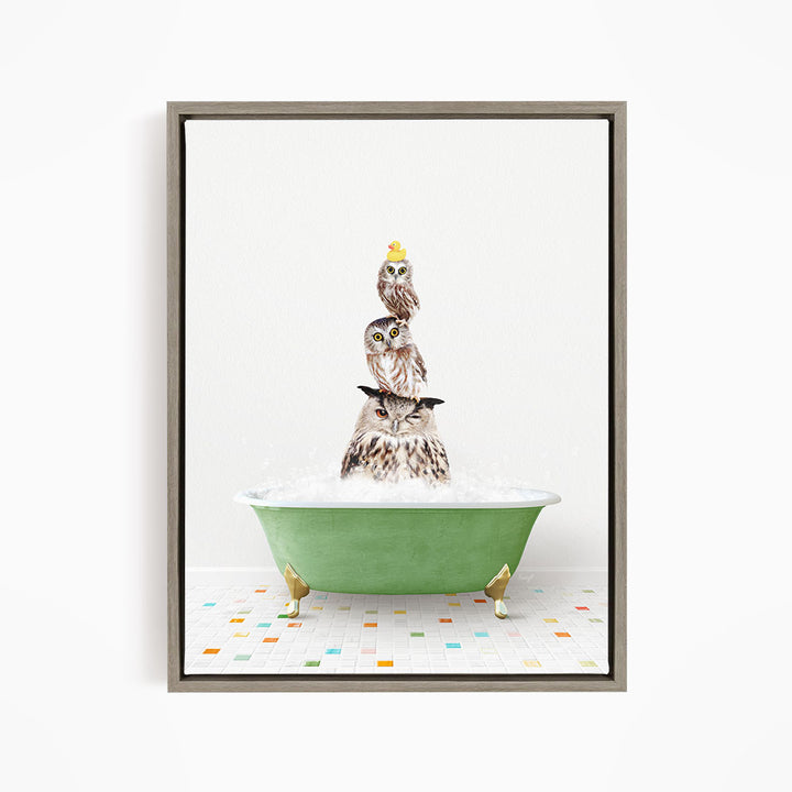 A framed image depicting three owls sitting in a green bathtub filled with bubbles, with one of the owls wearing a yellow hat.