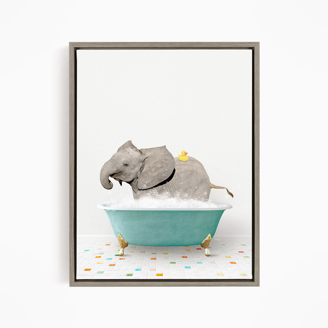 A gray elephant is sitting in a blue bathtub filled with water, with a yellow rubber duck floating on its back.