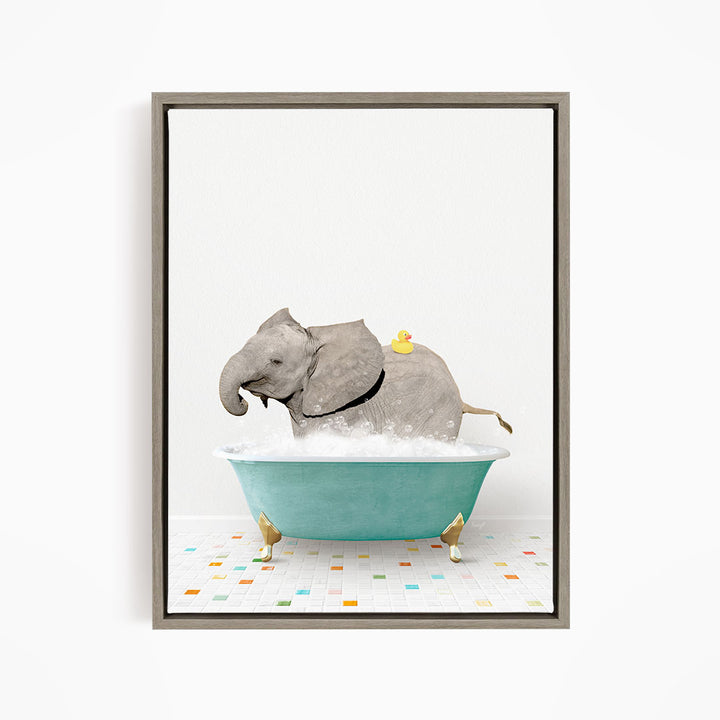 A gray elephant is sitting in a blue bathtub filled with water, with a yellow rubber duck floating on its back.
