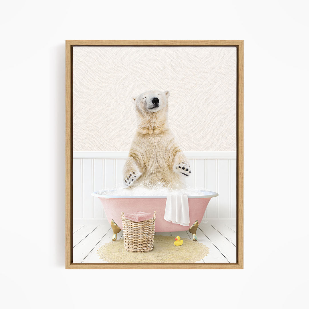 A polar bear sitting in a pink bathtub filled with bubbles, surrounded by a basket of rubber ducks and a towel.