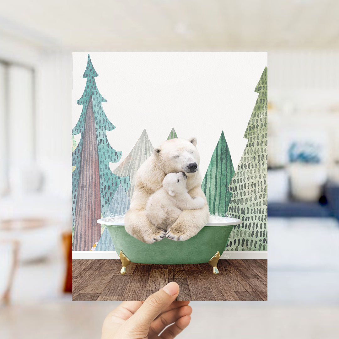 A hand holds up a framed image depicting a polar bear sitting in a bathtub, surrounded by a snowy landscape with trees and mountains in the background.