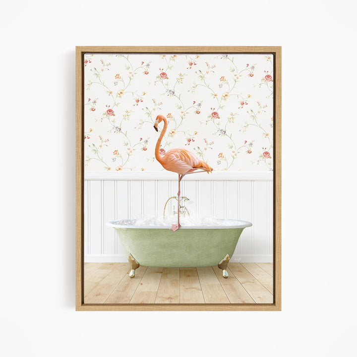 A pink flamingo stands on the edge of a green bathtub, with a floral wallpaper in the background.