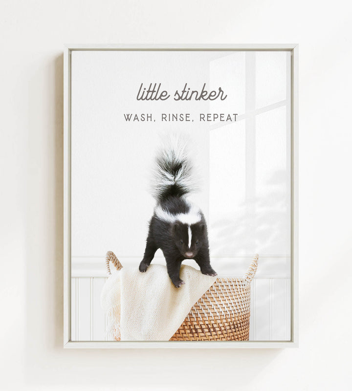 A black and white skunk standing on a woven basket in a bathroom.