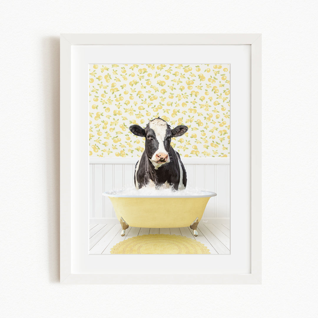 A black and white cow is sitting in a yellow bathtub filled with water, surrounded by a yellow floral pattern on the wall behind it.