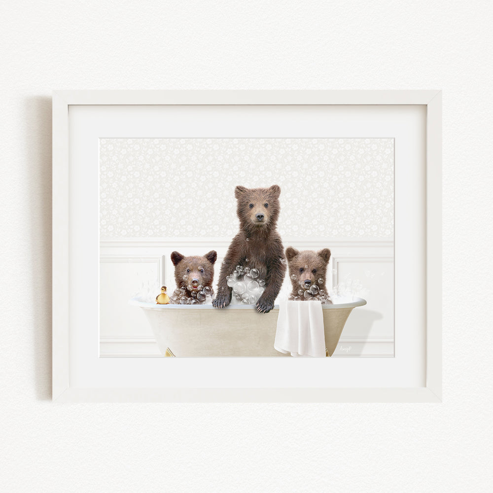 A framed image depicting three bears sitting in a bathtub, with one bear standing and the other two sitting.