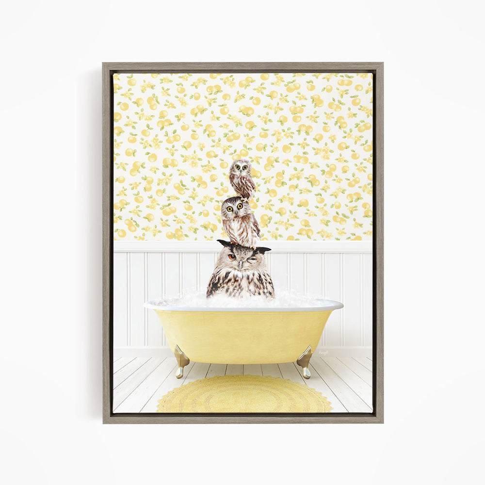 A framed image depicting three owls sitting in a yellow bathtub, with a yellow and white floral wallpaper in the background.