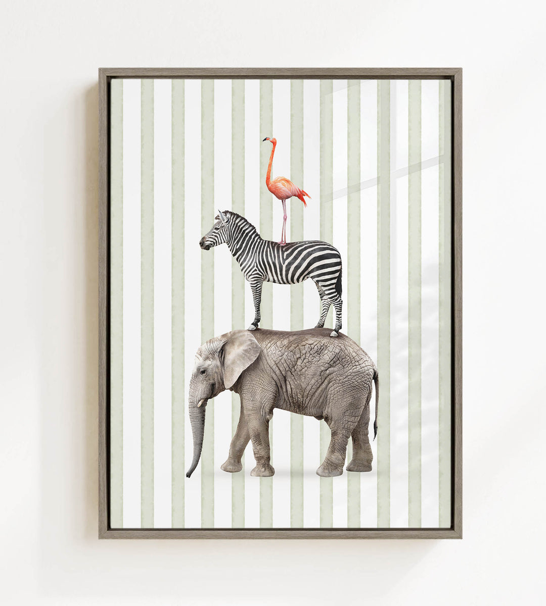A framed collage of three animals: a zebra, an elephant, and a flamingo, standing on top of each other against a striped background.