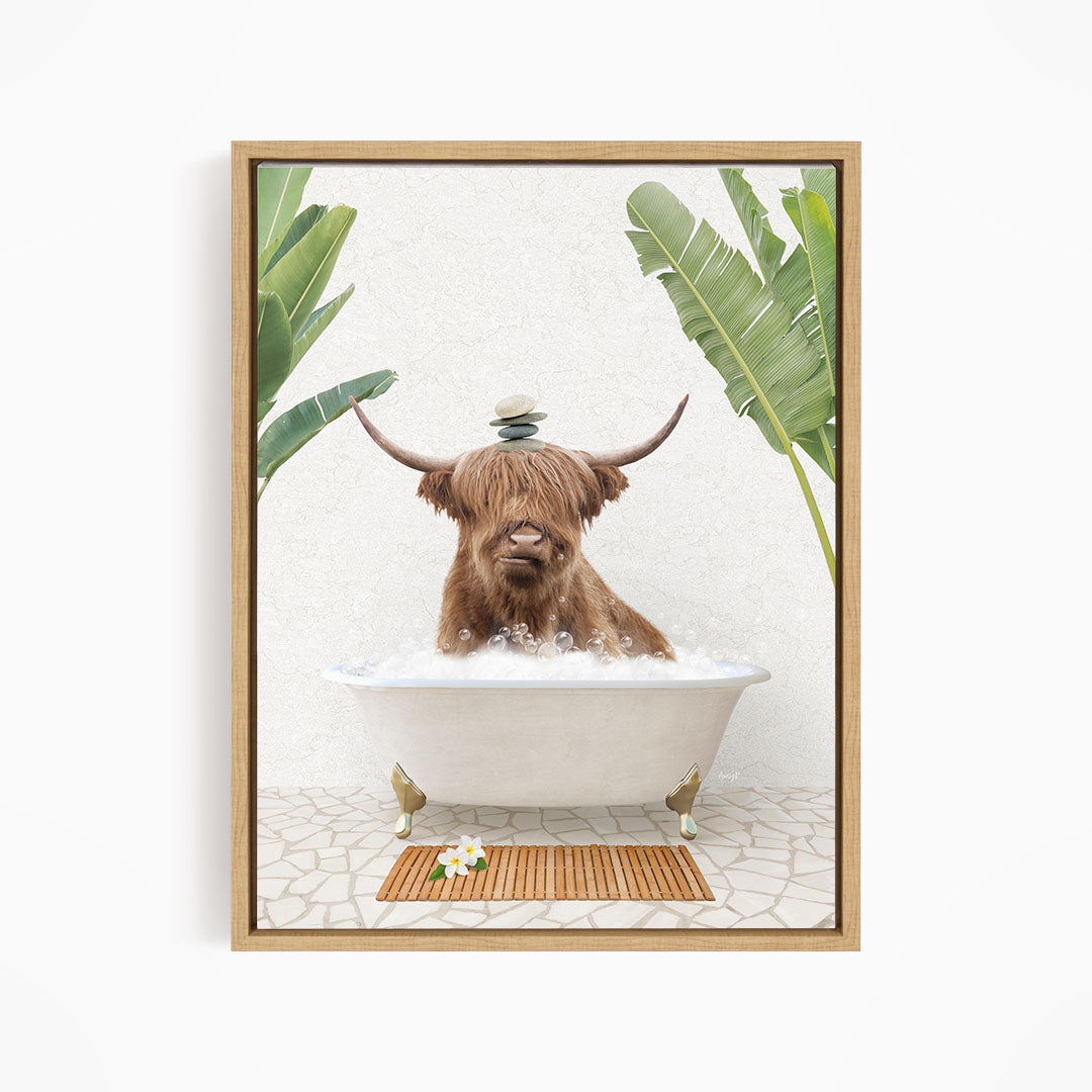A brown cow with long horns is sitting in a white bathtub filled with bubbles, surrounded by tropical plants and a wooden mat on the floor.
