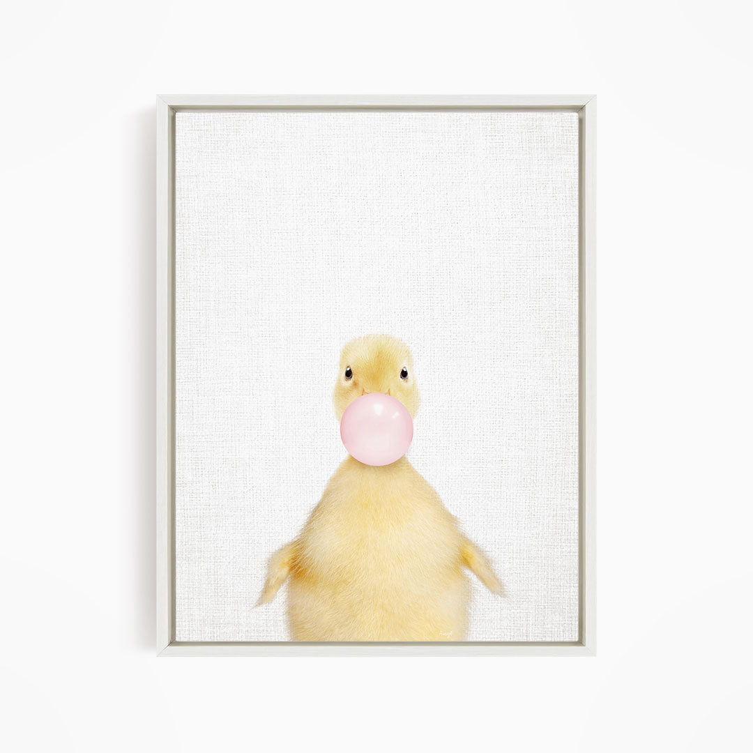 A cute yellow duck blowing a bubble with a pink bubble gum bubble.