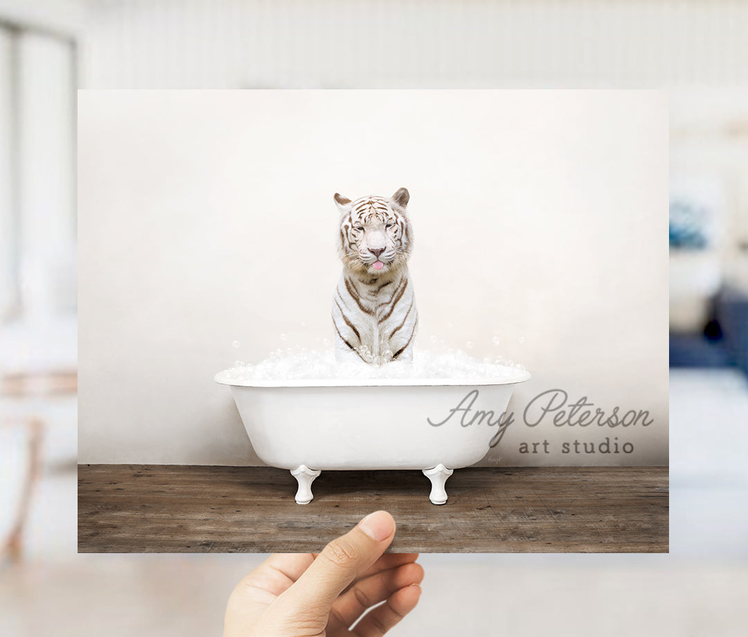 a hand holding a card with a picture of a white tiger in a bathtub