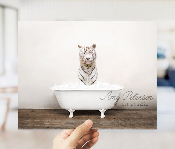 a hand holding a card with a picture of a white tiger in a bathtub