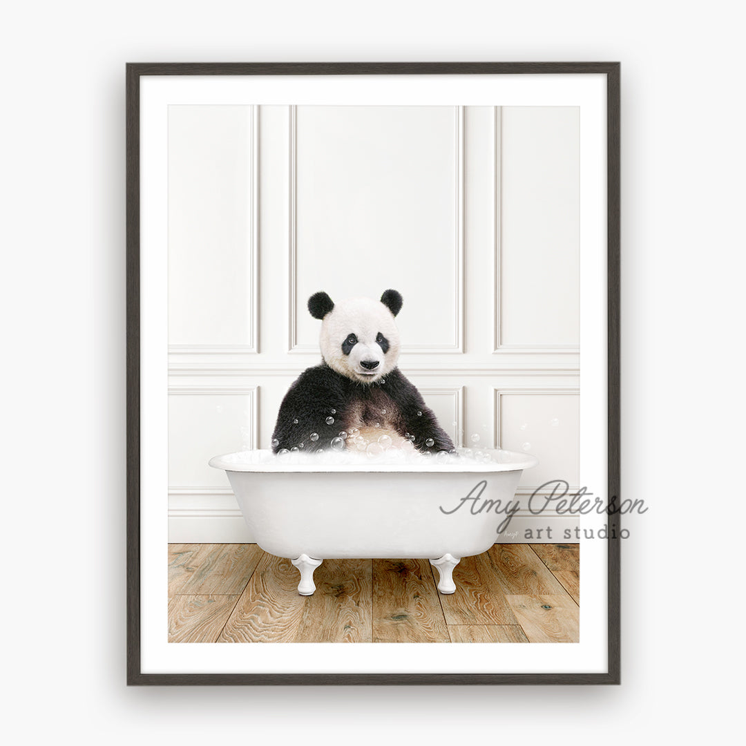 a black and white panda bear sitting in a bathtub